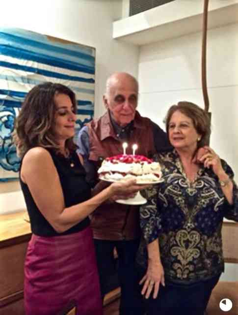 Renata Salgado segurando o bolo, com os amigos Mary e Zuenir Ventura